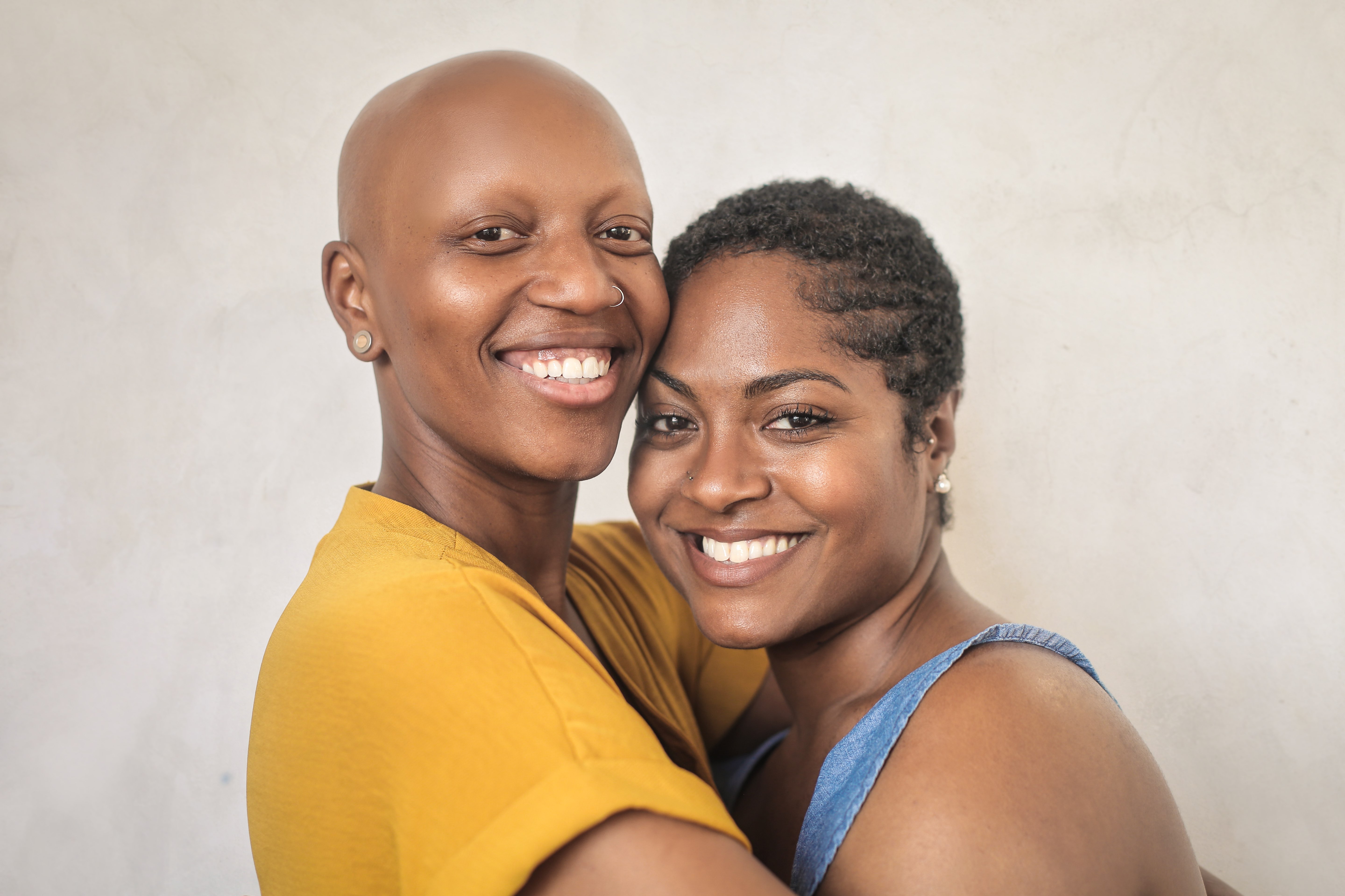 Black same-sex couple hugging and smiling